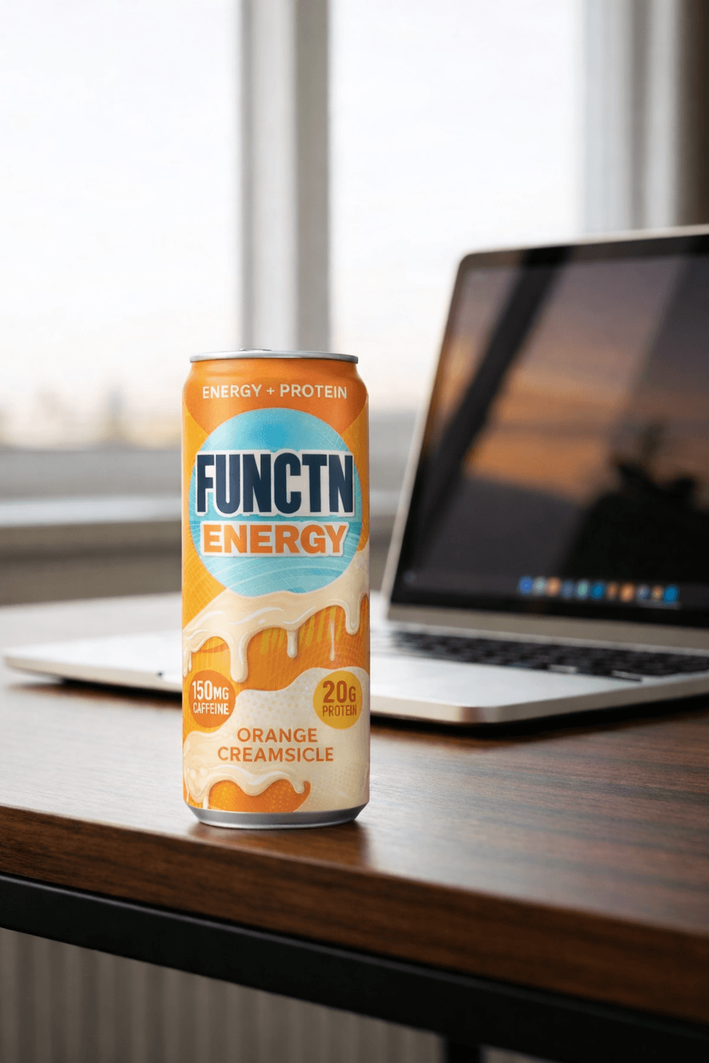 FUNCTN Energy Orange Creamsicle can on a desk next to a laptop